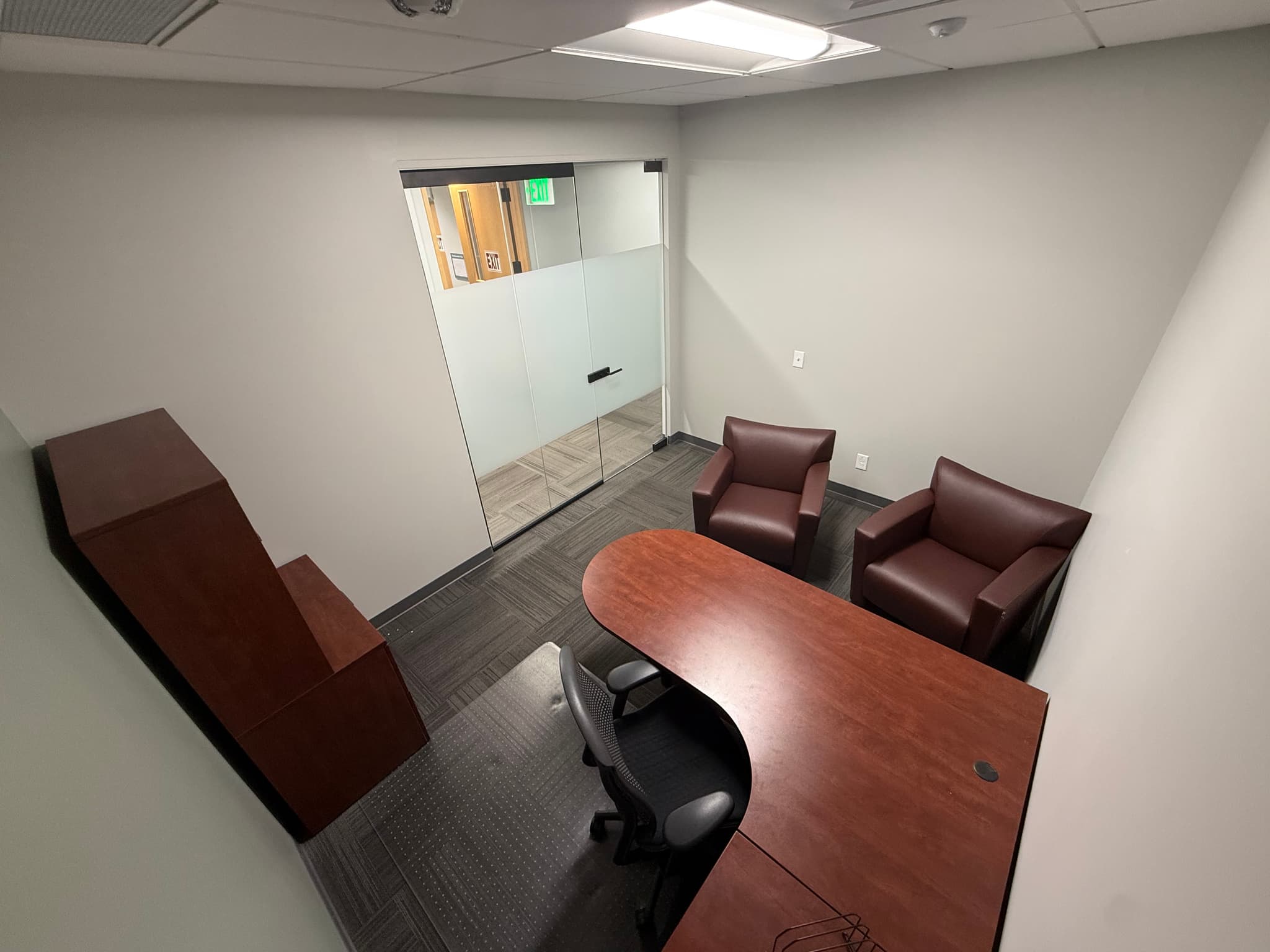Large office space with multiple workstations and ample room for teams